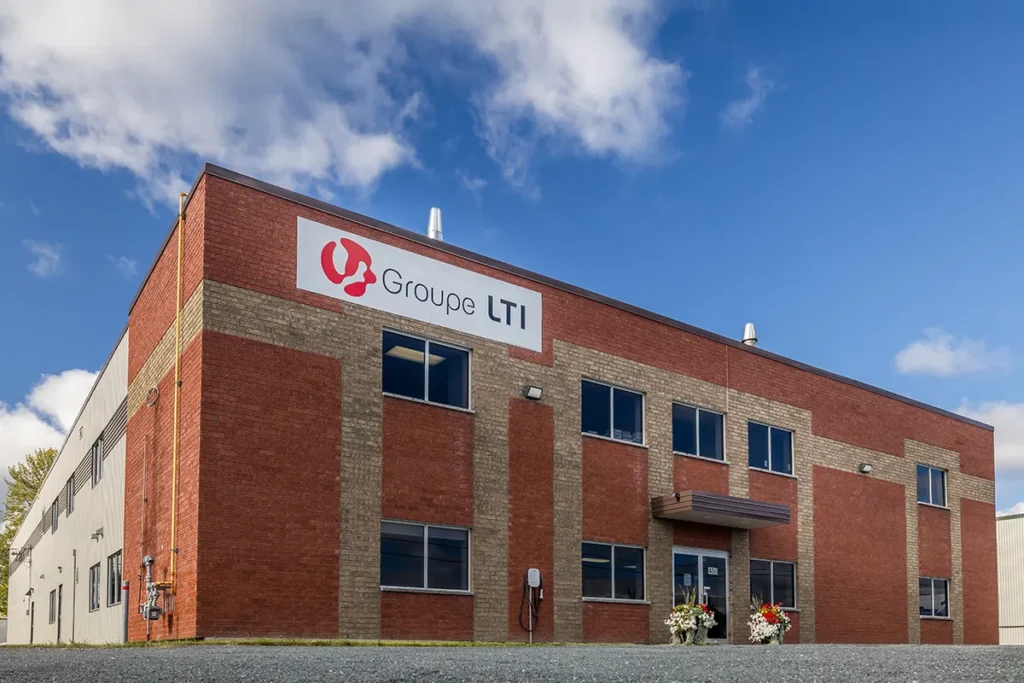 Exterior view of LTI Group’s brick building with visible sign and main entrance in Val-des-Sources.